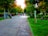 A peaceful park scene with people enjoying a sunny day.