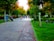 A peaceful park scene with people enjoying a sunny day.