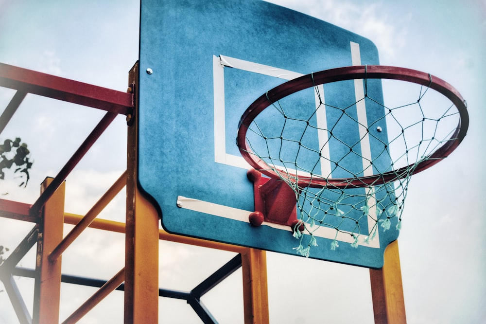 red steel basketball ring mounted or blue wooden basketball board