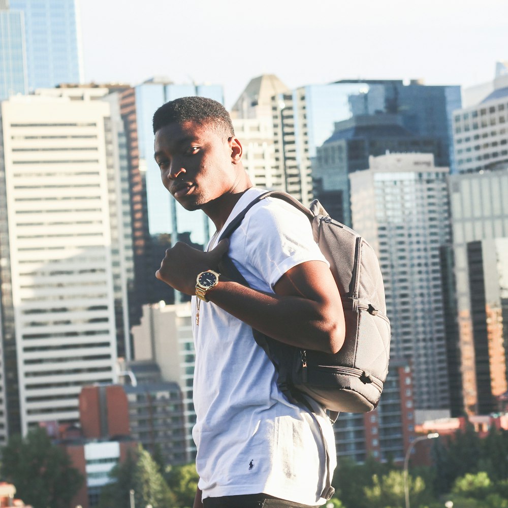 man carrying gray backpack standing