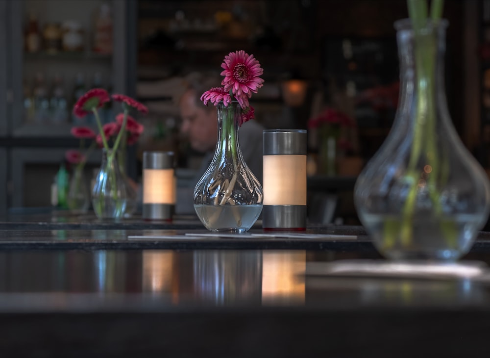 pink petaled flower in vase on tabletop