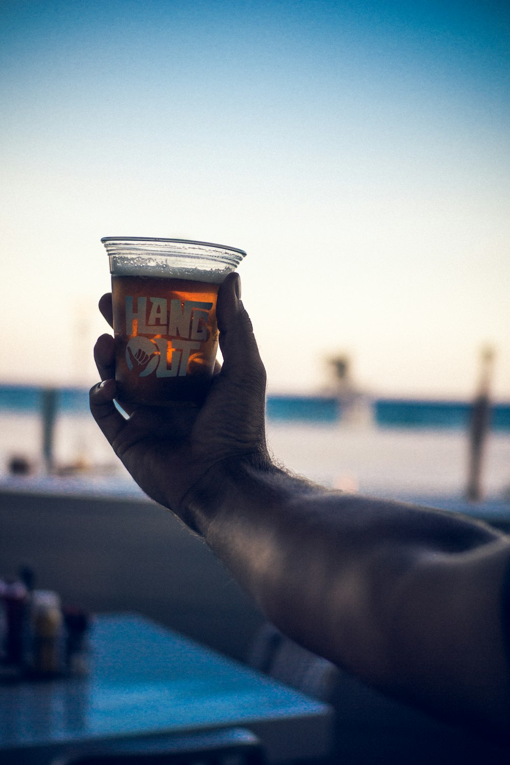 person holding cup of beverage