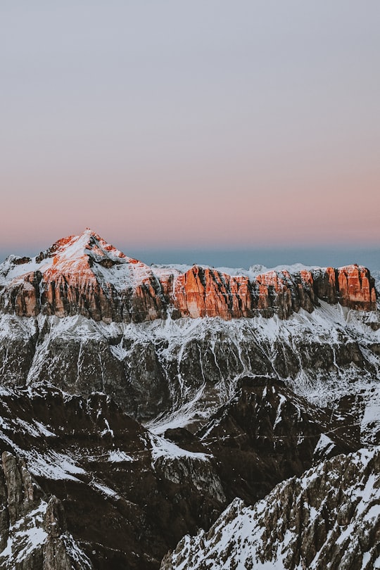 photography of mountains covered by snow at daytime in Dolomites Italy