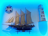 Certificates displayed proudly on a desk beside a ship model and maritime manuals.