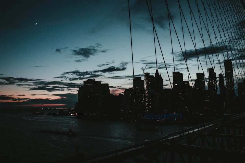 silhouette of buildings under clear blue sky