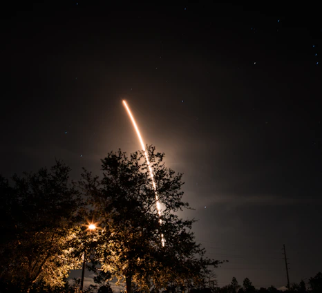 A stunning night sky filled with stars and a rocket launching into space.