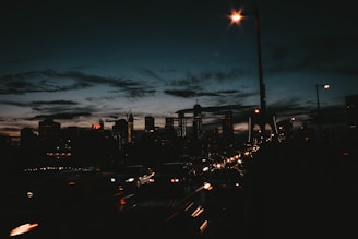A city skyline at dusk with service trucks lined up ready for dispatch.