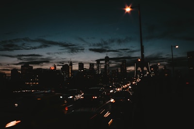 A city skyline at dusk with service trucks lined up ready for dispatch.