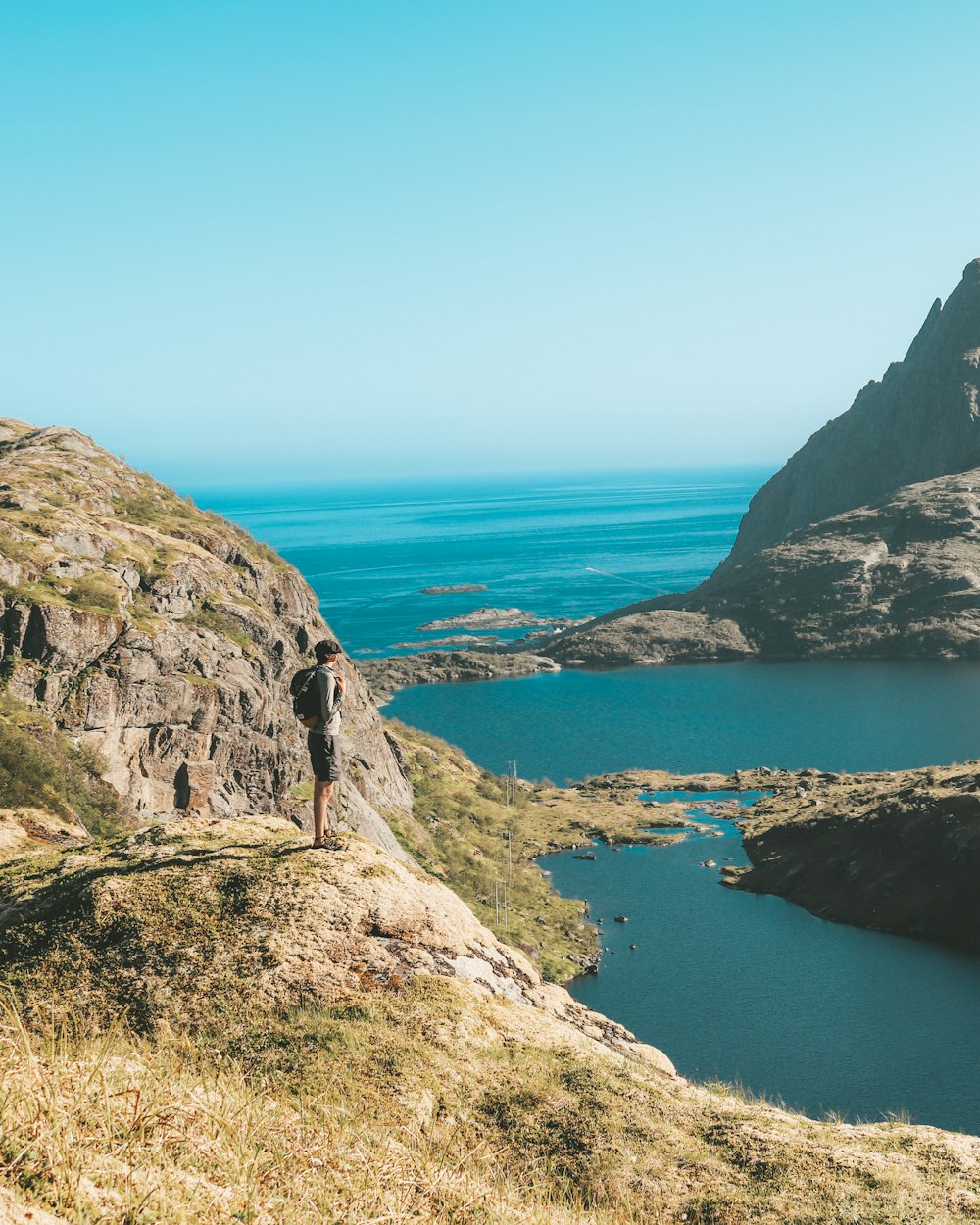 man standing on edge of mountain