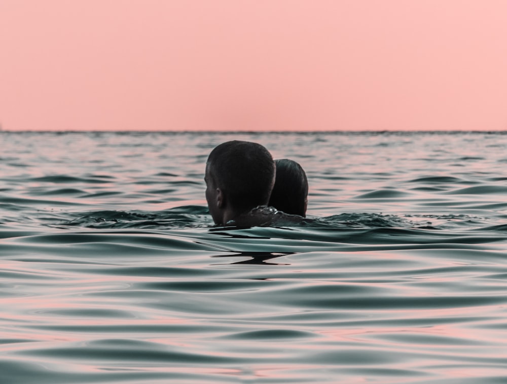 man and woman on blue ocean water