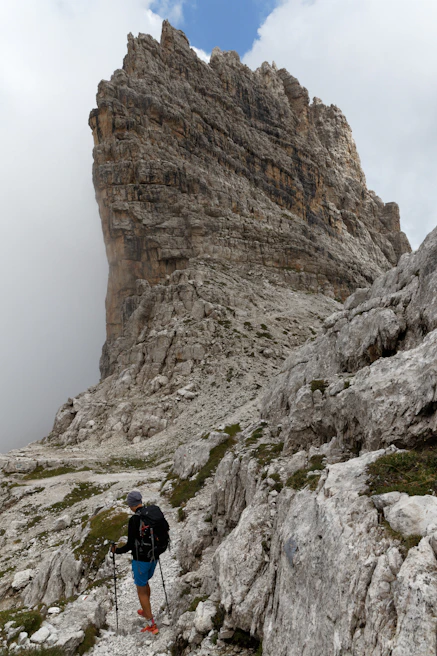 Close-up of a hiker gripping a sturdy trekking pole on a rocky trail