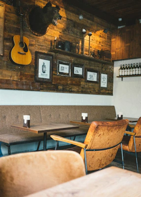 Warm wooden cabin wall adorned with handcrafted lodge-themed signs and nature-inspired art