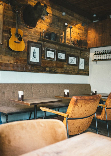 A cozy workshop with mounted animal heads and handcrafted western decor pieces displayed.