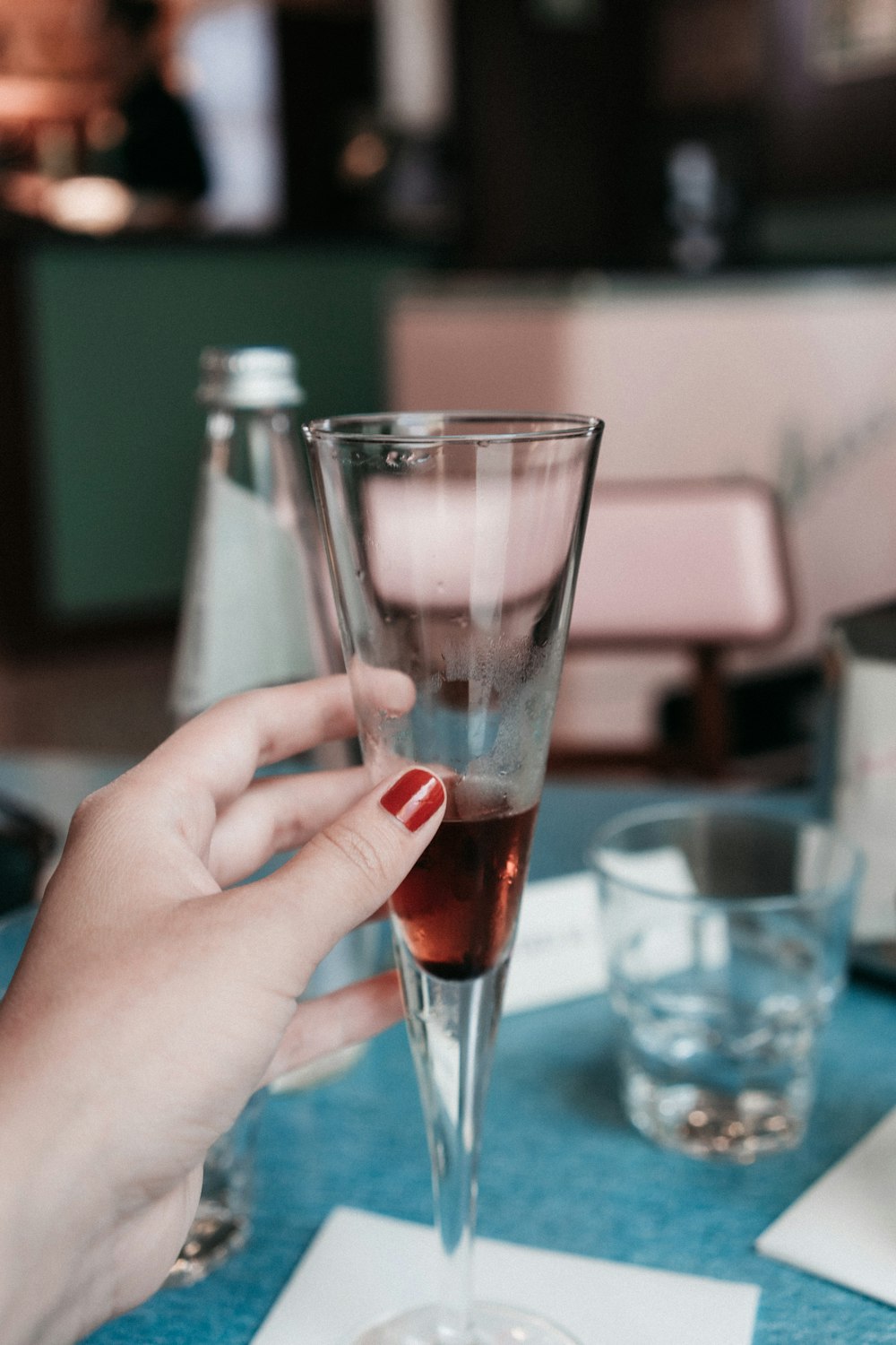 person holding clear wine glass