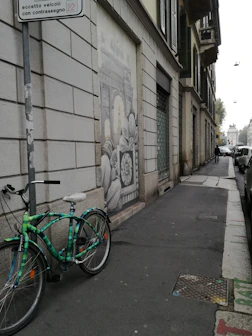 A solo traveler studying a map on a quiet city street surrounded by secret murals.