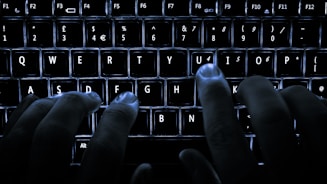 Hands typing on a keyboard with digital interface overlay