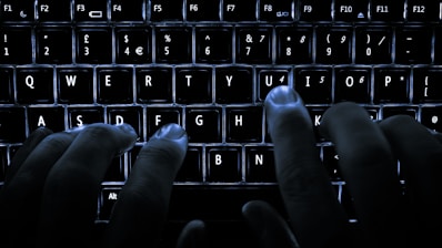 Hands typing on a keyboard with digital interface overlay
