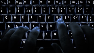 Hands typing on a keyboard with a background of earthy tones and social media icons softly glowing.