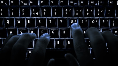 Hands typing on a laptop in a dimly lit room emphasizing secure, offline technology.