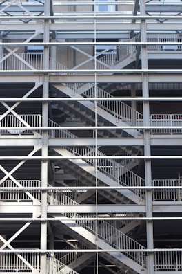 A metal framework consisting of multiple levels, with crisscrossing staircases and railings. The structure is symmetrical and grid-like, providing an industrial appearance.
