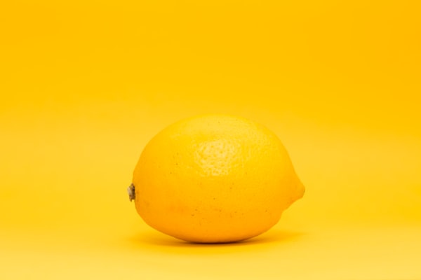 a lemon against a lemon-yellow background