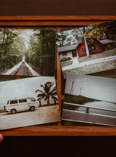 person holding four photos