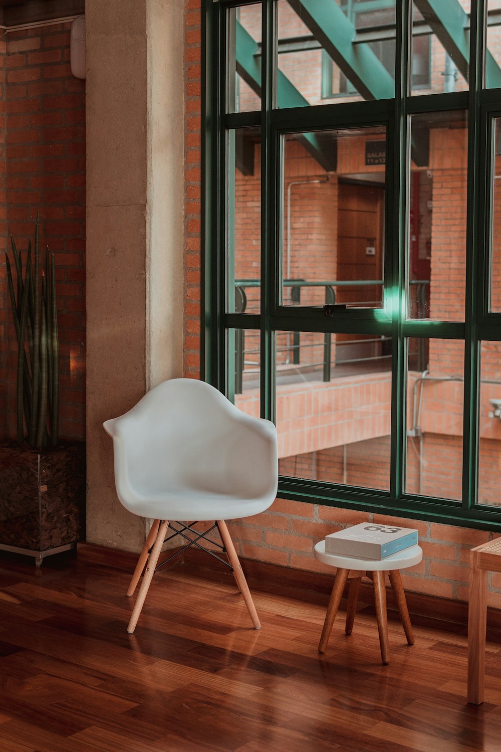 white armchair near glass window