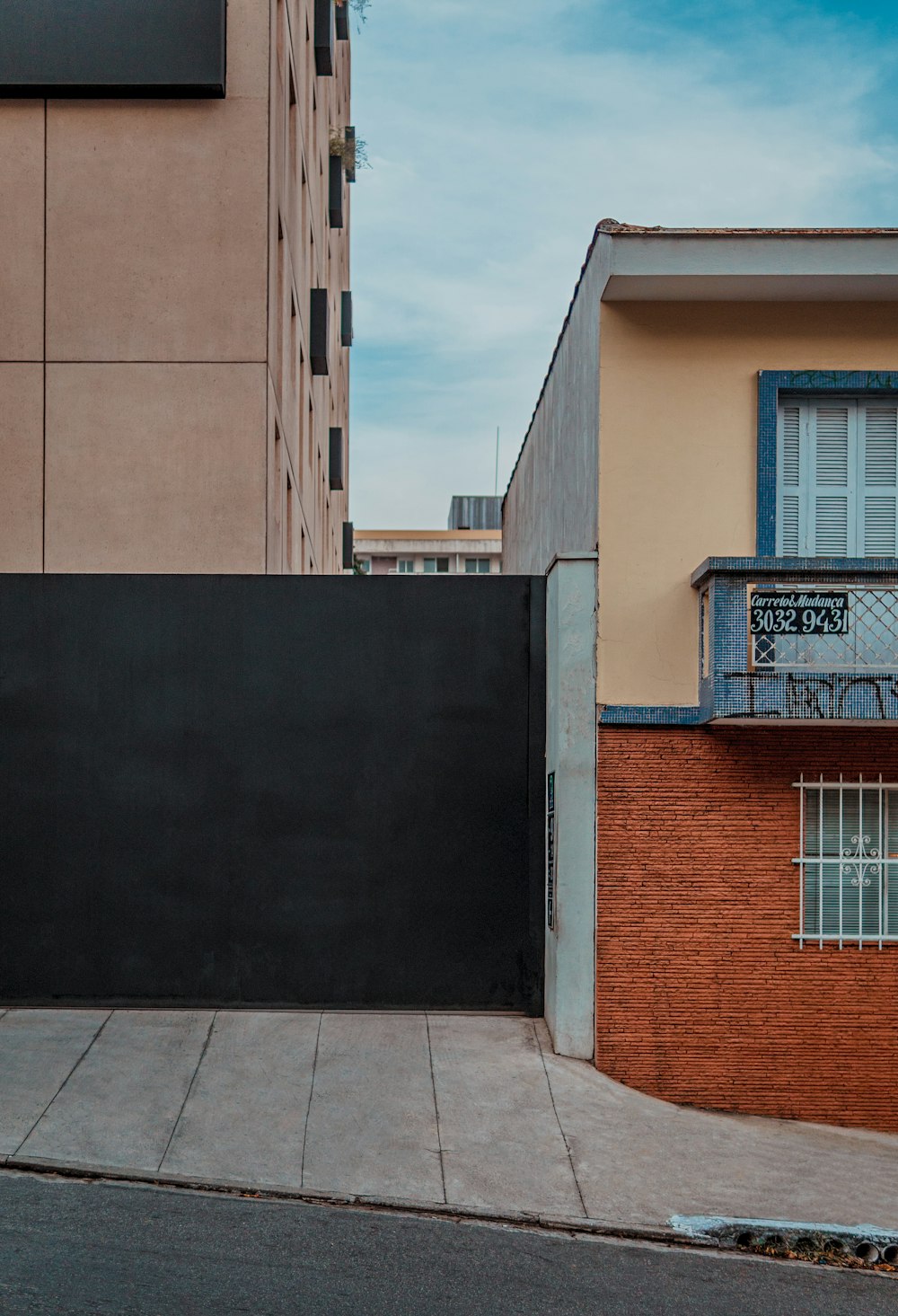 beige concrete house under cloudy skyt