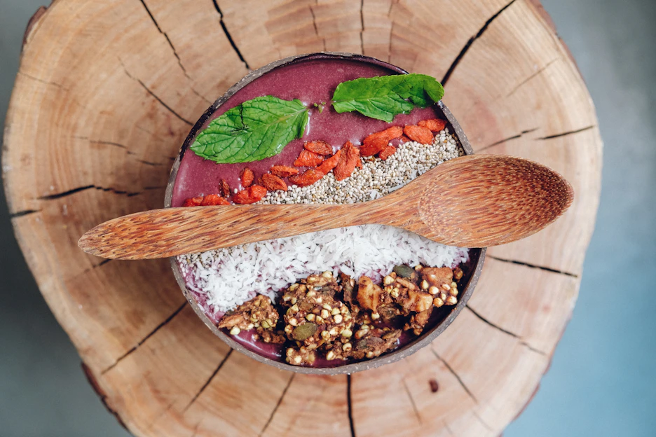 Close-up of a trending nutrient-rich superfood blend in a rustic bowl with fresh herbs around