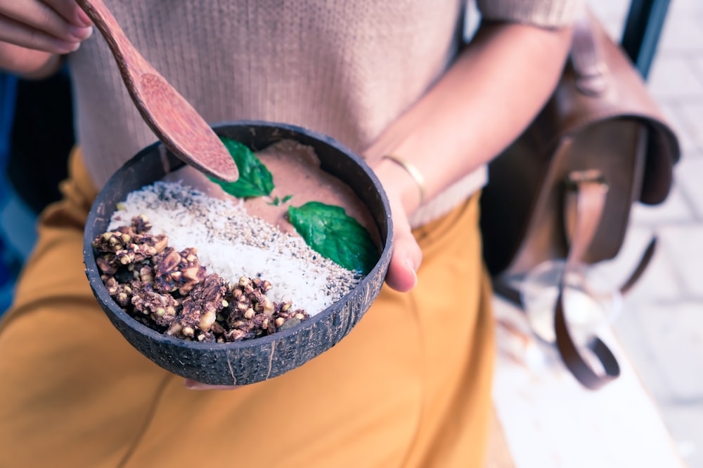 person holding black bowl