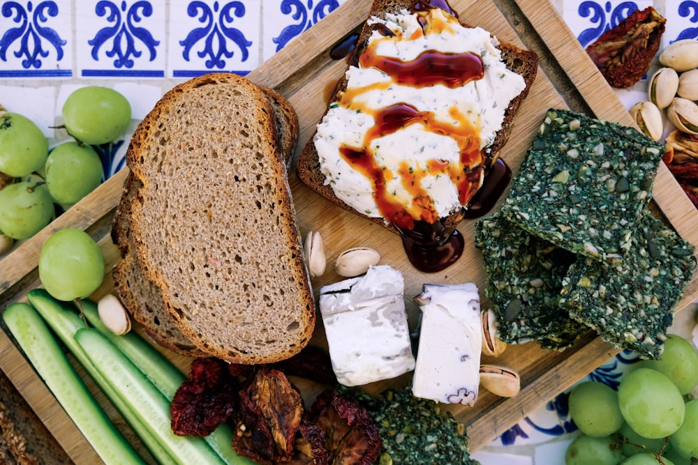 bread and vegetables on brown wooden board