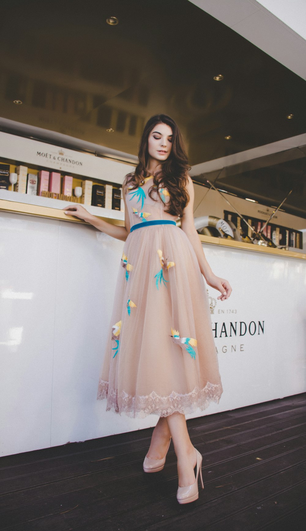 woman wearing peach-colored maxi dress