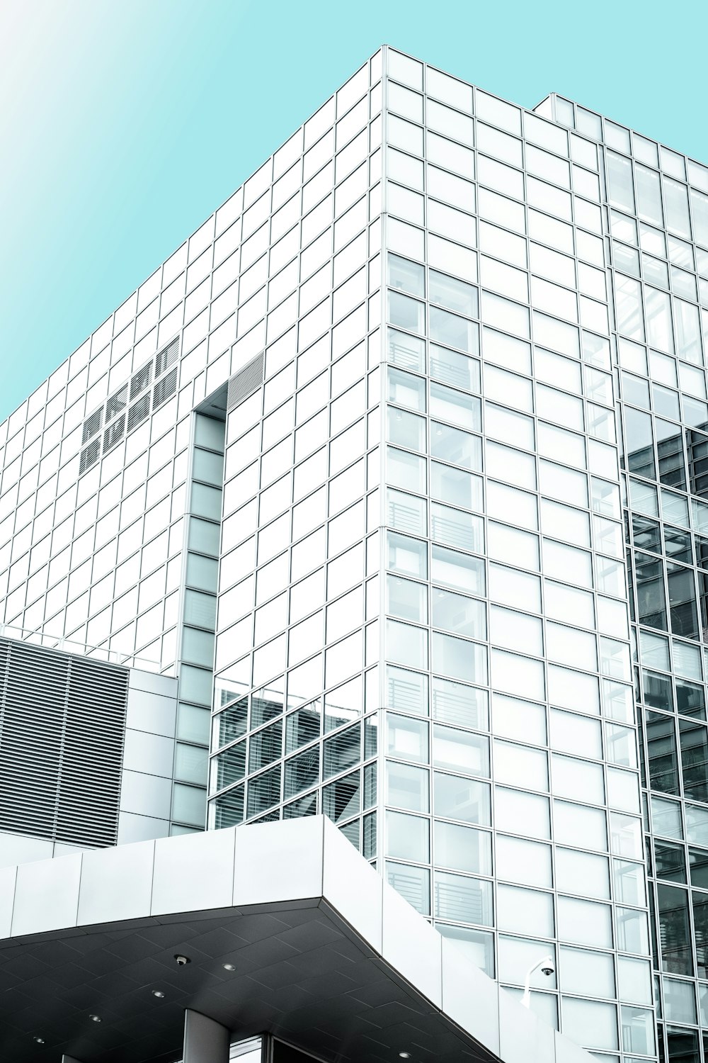 white and clear glass high-rise building