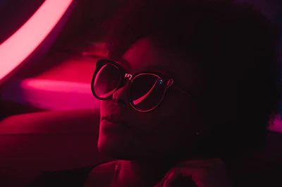 A high-fashion editorial shot featuring dramatic shadows and a neon lime-green backdrop.