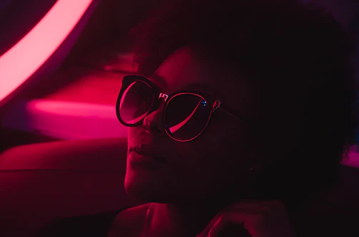 High-fashion editorial photo with deep shadows and neon lime highlights.