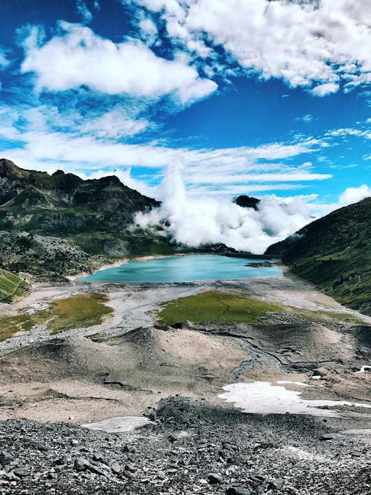 body of water between mountains under cloudy sky in Lac de Salanfe Switzerland