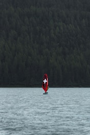 a boat with a cross on it is in the water