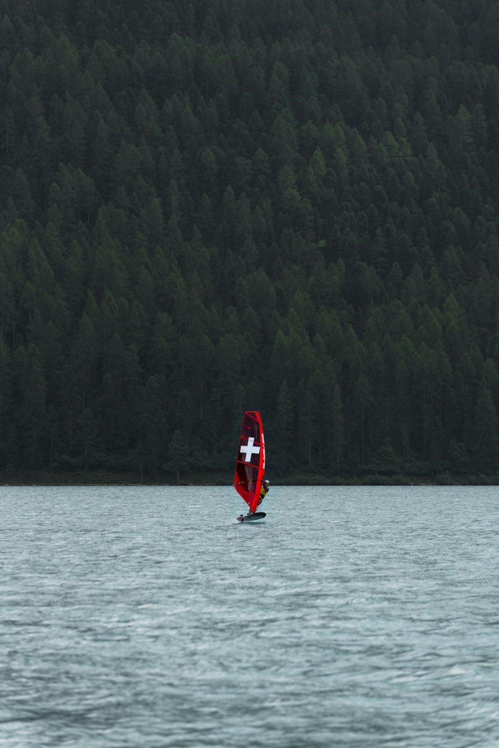 a boat with a cross on it is in the water