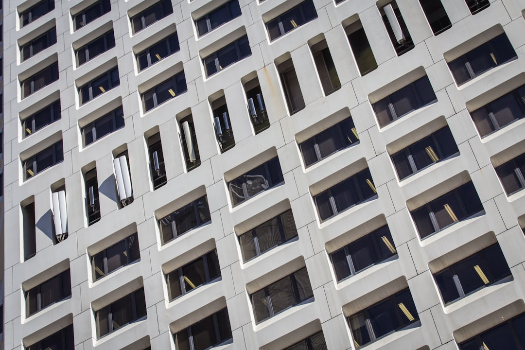 low angle photo of gray concrete building