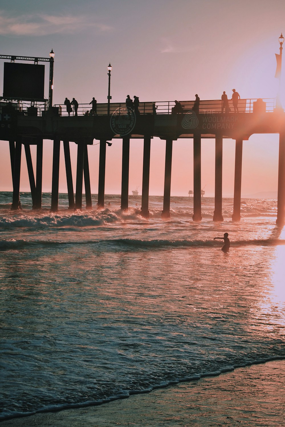 people standing on dock above body of water