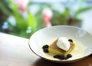 cake with cream in bowl on brown surface