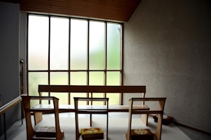 Calm treatment space with natural light filtering through linen curtains and minimalist wooden furniture