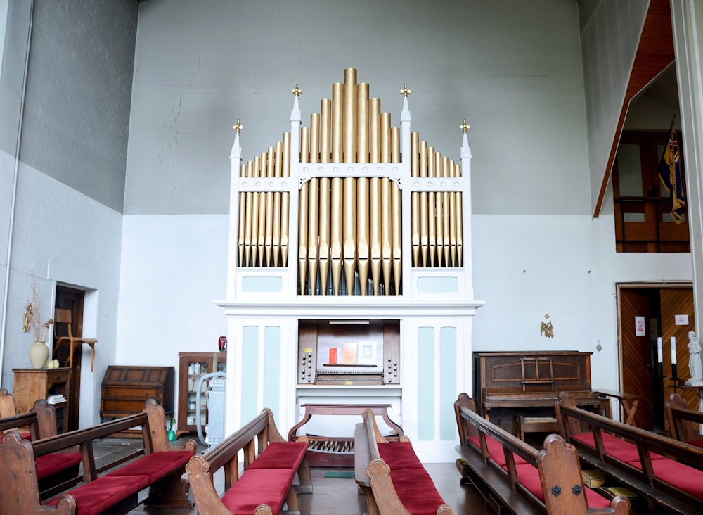 brown wooden framed red padded pews inside building