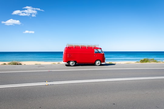 red van on asphalt road near the seashore in Palm Beach Australia