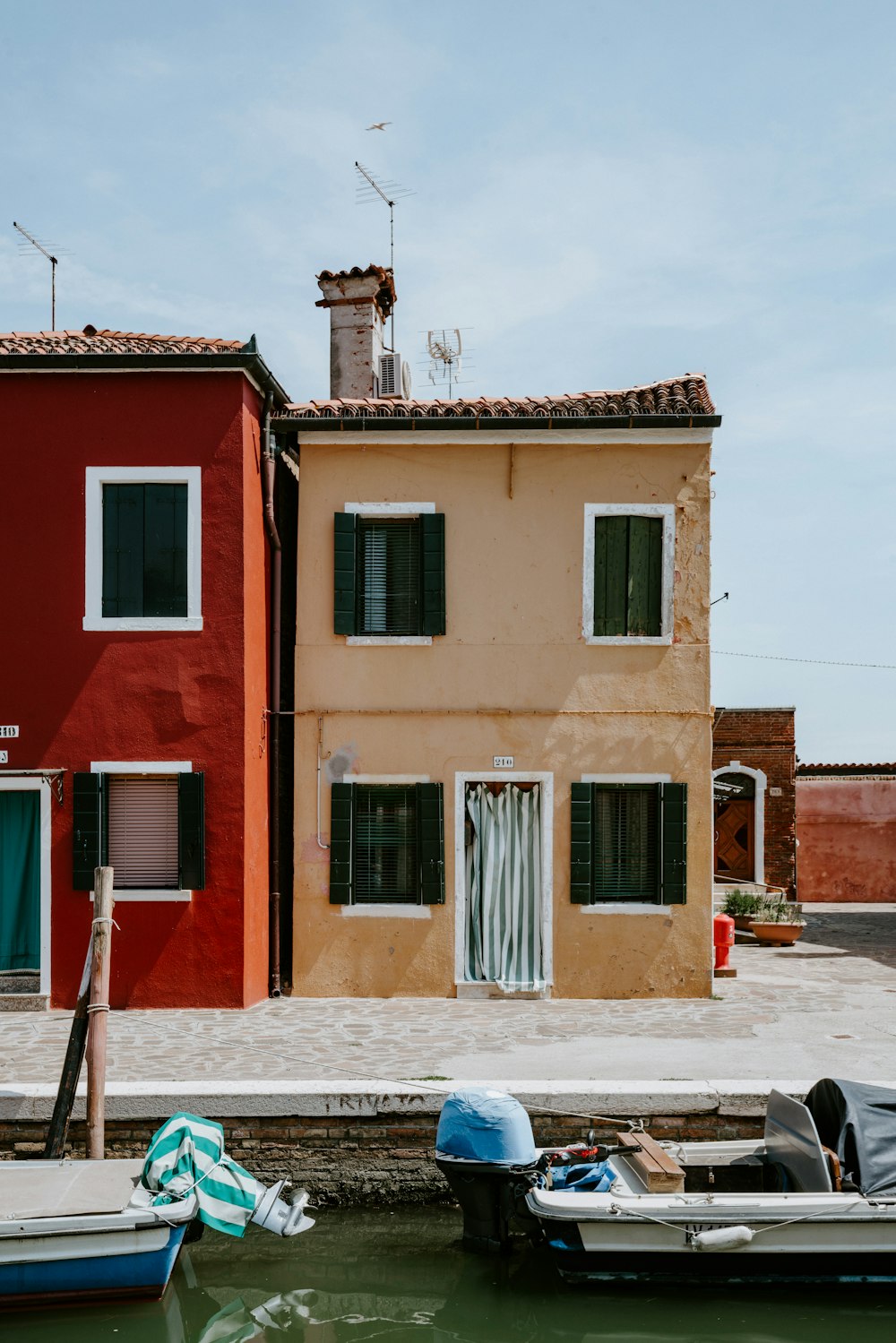 two red and beige concrete buildings during daytime