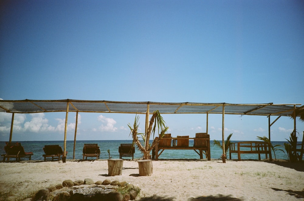 benches and chairs under roof with bamboo posts