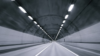 time lapse photography of vehicle under tunnel