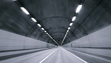 time lapse photography of vehicle under tunnel