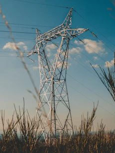 gray power line under blue sky