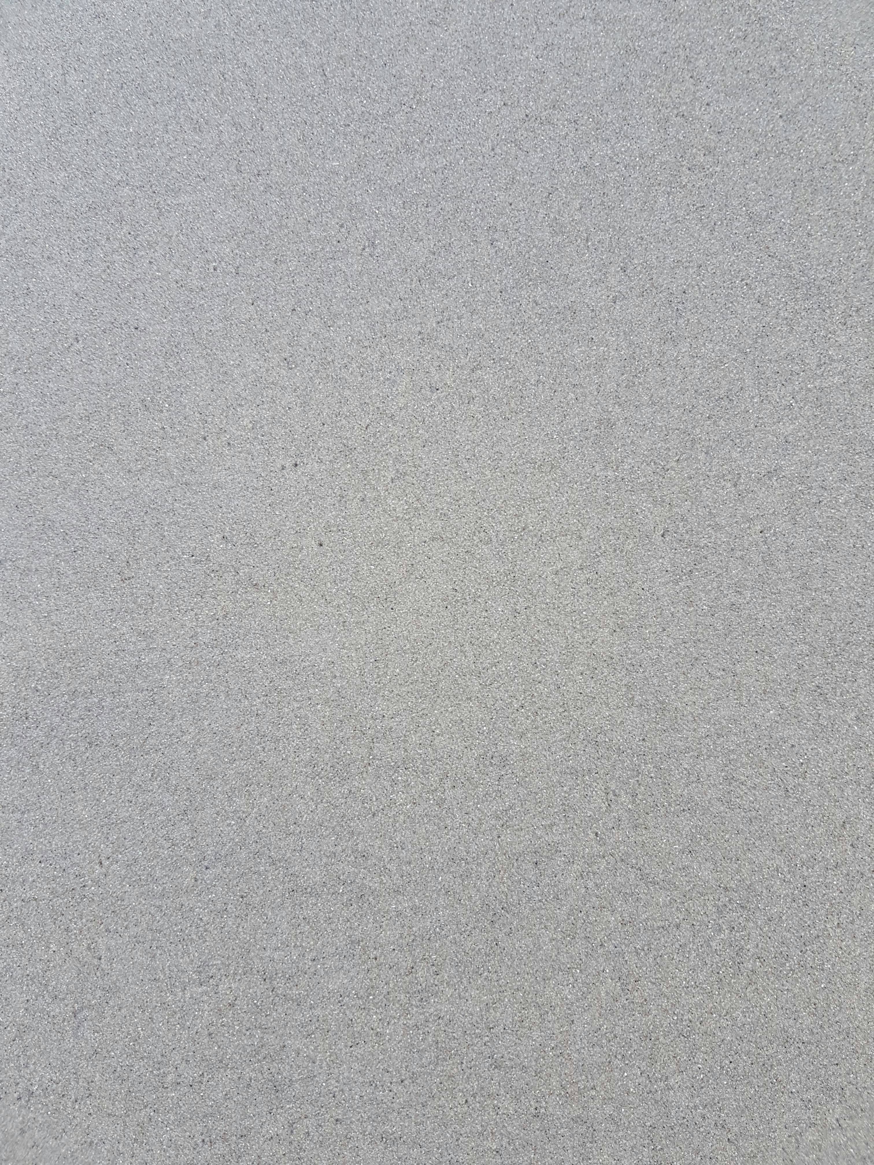 a bird is standing on the sand of the beach